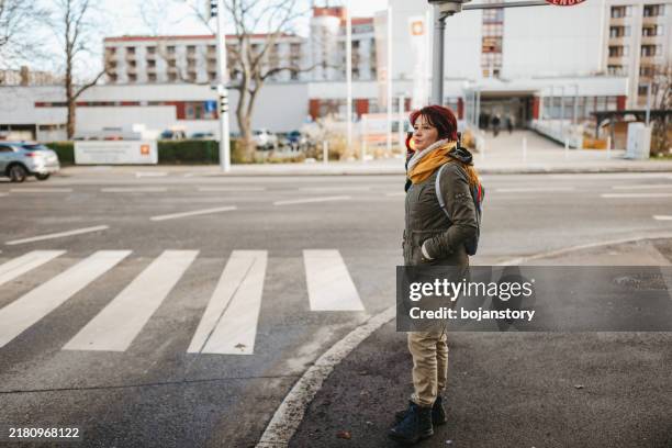 woman waiting to cross the street - zebra crossing wait stock pictures, royalty-free photos & images