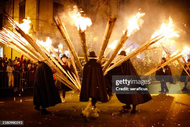 agnone, molise (italy): men carrying flaming torches during the 'ndocciata parade - medieval torch stock pictures, royalty-free photos & images