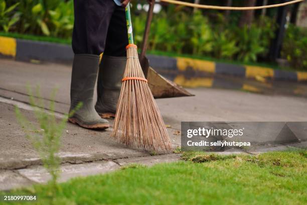 diligent janitor sweeping the yard - man sweeping stock pictures, royalty-free photos & images