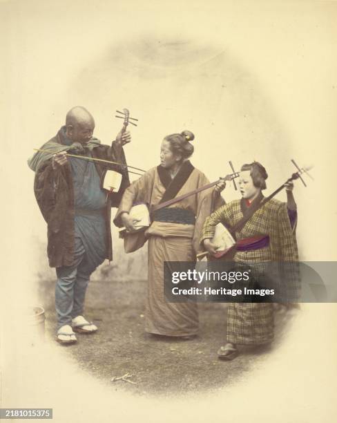 Street Musicians, 1866-1867. One man and two women with stringed instruments. Creator: Felice Beato.