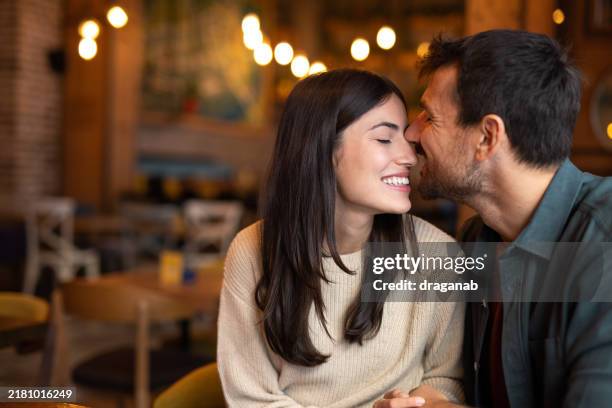 precious moments of love - cheek kiss stock pictures, royalty-free photos & images