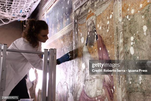 Restorers at work on the italian artist Giotto di Bondone frescos of the Life of San Francesco cycle at Bardi Chapel at Basilica di Santa Croce on...