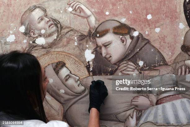 Restorers at work on the italian artist Giotto di Bondone frescos of the Life of San Francesco cycle at Bardi Chapel at Basilica di Santa Croce on...