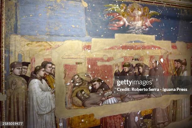 Restorers at work on the italian artist Giotto di Bondone frescos of the Life of San Francesco cycle at Bardi Chapel at Basilica di Santa Croce on...