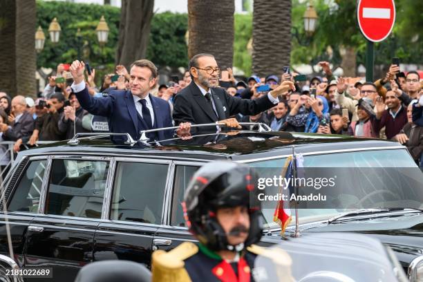 French President Emmanuel Macron greets the public on the same vehicle with King of Morocco Mohammed VI during his official visit in Rabat, Morocco...