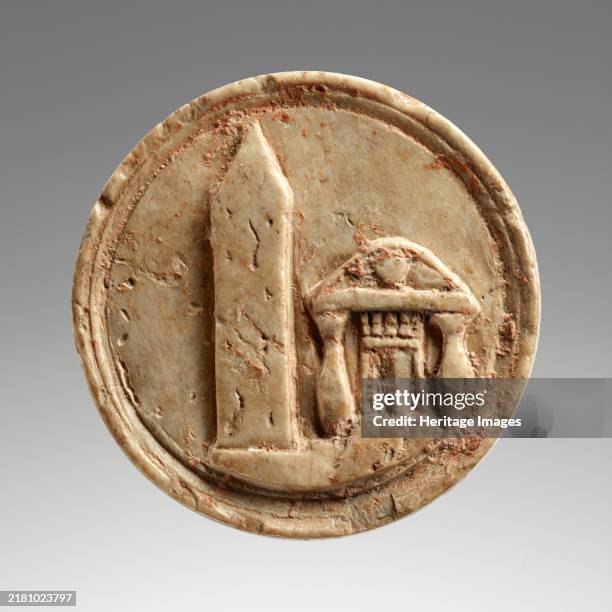 Token with an Egyptian Obelisk and a Temple, early 1st century A.D. This circular token probably served as a game counter. The obverse shows an...