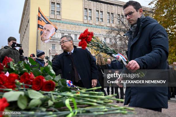 Foreign diplomats lay flowers at the monument for the victims of political repressions in front of the FSB security service headquarters as a...