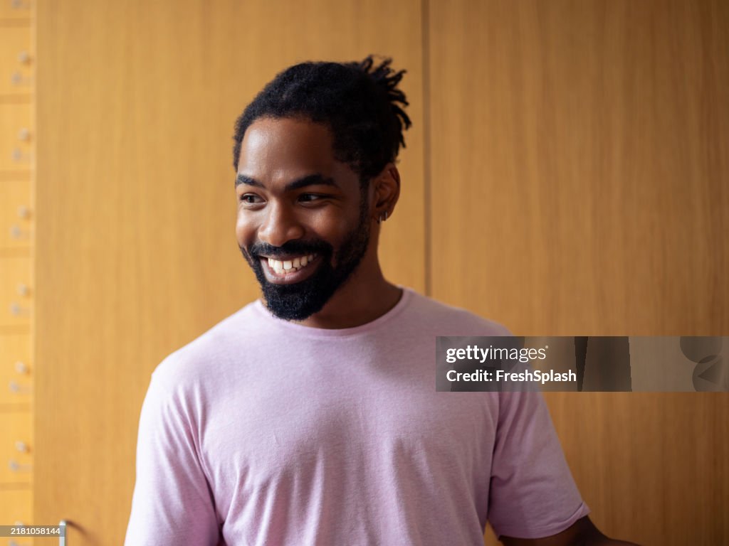 Smiling Man in Casual T-Shirt Looking Confident and Relaxed
