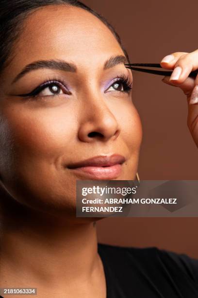 woman plucking eyebrows with tweezers, close up beauty portrait - tweezing eyebrows stock pictures, royalty-free photos & images