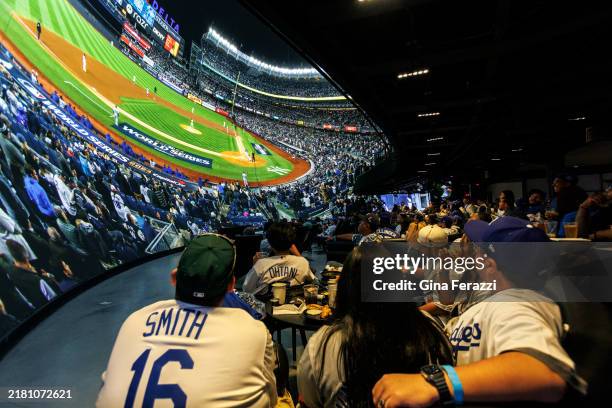 Dodgers fans watch a giant LED screen showing Game 3 of the World Series between the Dodgers and the New York Yankees live in the Dome at Cosm Los...