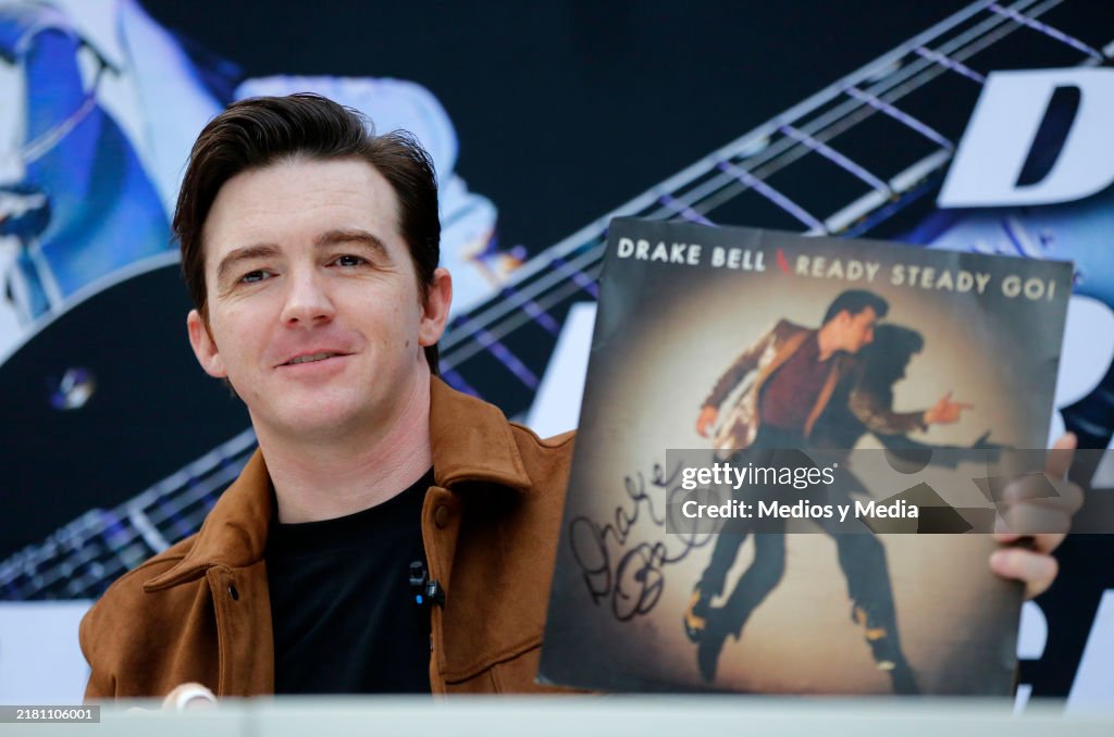 Drake Bell Singer Singer Drake Bell shows his own album during a fan meet and greet and ...