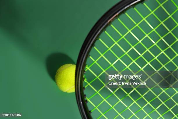 sport concept with tennis ball and tennis racket on hard green tennis court background with shadow. - wimbledon tennis court stock pictures, royalty-free photos & images