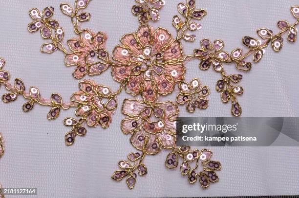 close-up of pink and gold embroidery on white fabric - white gold sequin dress stock pictures, royalty-free photos & images