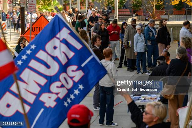 Voters line up to apply for their mail-in or absentee ballots outside the Allegheny County Office Building on October 29, 2024 in Pittsburgh,...