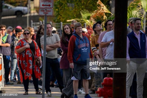 Voters line up to apply for their mail-in or absentee ballots outside the Allegheny County Office Building on October 29, 2024 in Pittsburgh,...