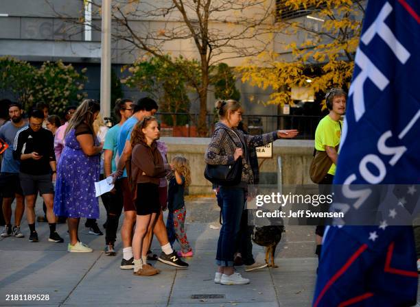 Voters line up to apply for their mail-in or absentee ballots outside the Allegheny County Office Building on October 29, 2024 in Pittsburgh,...