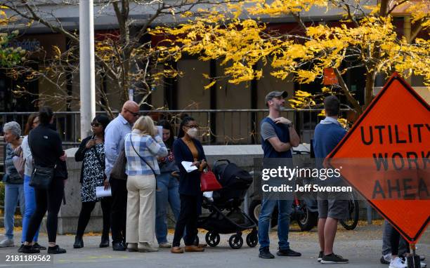 Voters line up to apply for their mail-in or absentee ballots outside the Allegheny County Office Building on October 29, 2024 in Pittsburgh,...