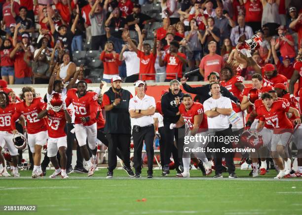 Houston Cougars head coach Willie Fritz and players react as they watch Houston Cougars place kicker Jack Martin successfully kick the winning field...