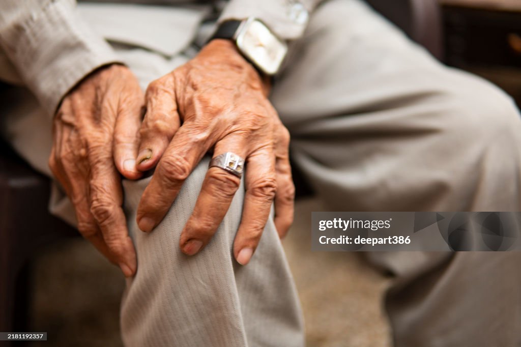 Senior indian man suffering from knee joint pain.