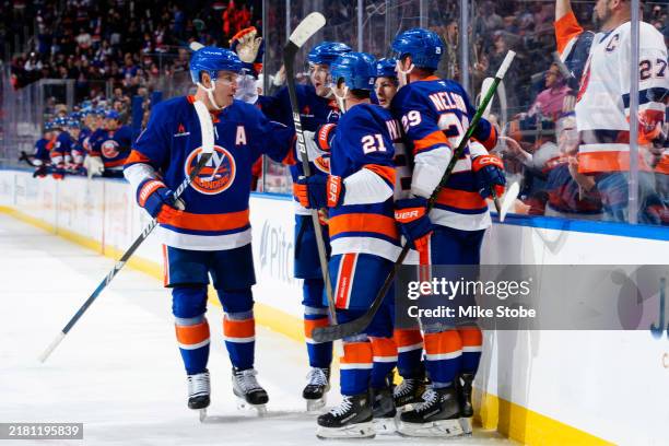 Mathew Barzal of the New York Islanders is congratulated by his teammates after scoring a goal against the Anaheim Ducks during the third period at...