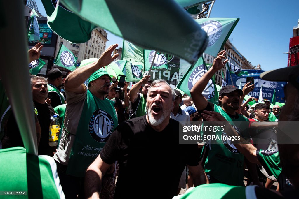Union leader Rodolfo Aguiar chants as he leads the...