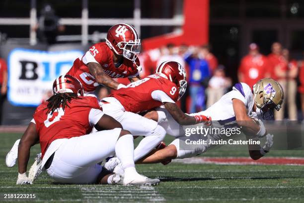 Denzel Boston of the Washington Huskies is tackled by Jamier Johnson and Amare Ferrell of the Indiana Hoosiers during the third quarter at Memorial...