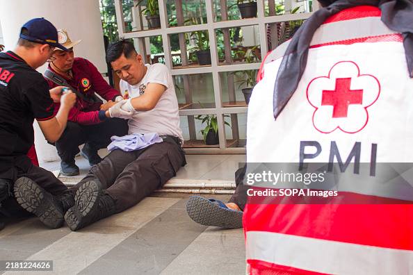 Health worker treats a man roleplaying as injured victim an Health worker treats a man roleplaying as injured victim an