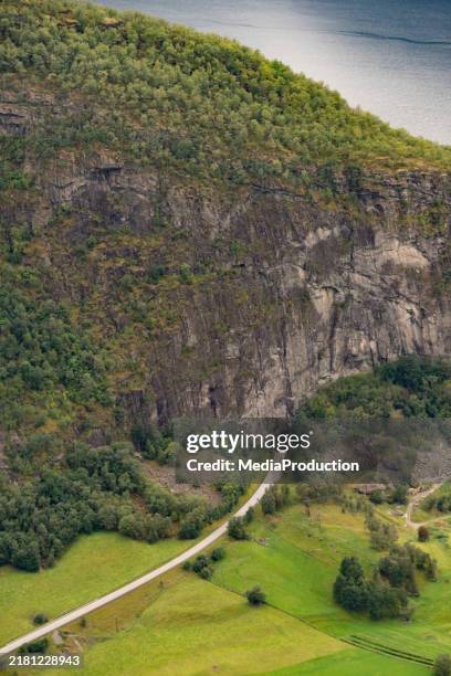 road going in to a tunnel under the fjords - tunnel stockfoto's en -beelden