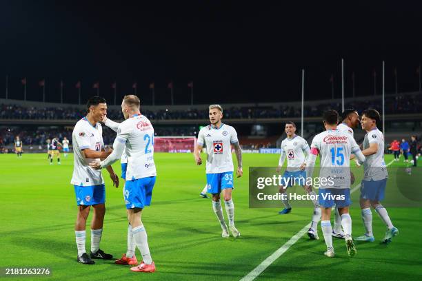 Angel Sepulveda of Cruz Azul celebrate with teammates after scoring the team's first goal during the 14th round match between Pumas UNAM and Cruz...