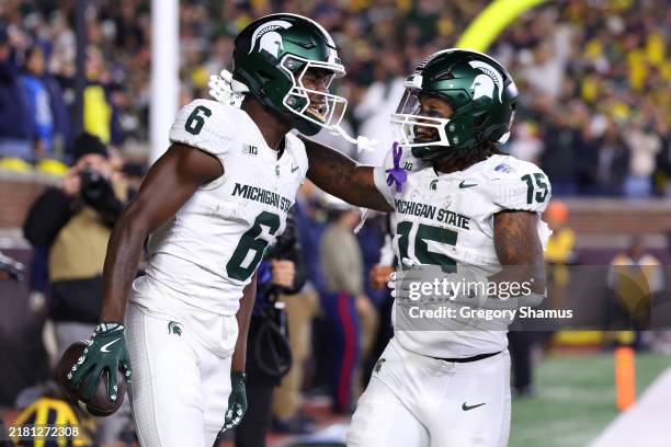 Nick Marsh of the Michigan State Spartans celebrates his touchdown catch with teammates during the fourth quarter against the Michigan Wolverines at...
