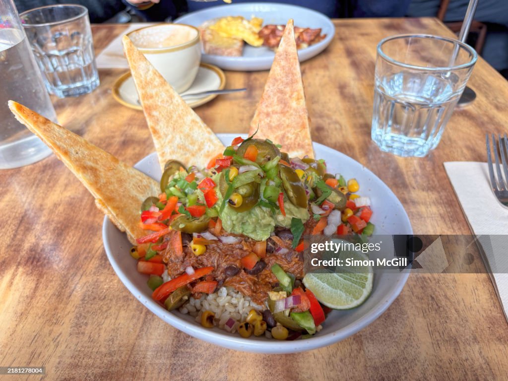 Burrito bowl of braised smokey pork, rice, crushed avocado, salsa, lime, jalapeno and manchego cheese quesadilla