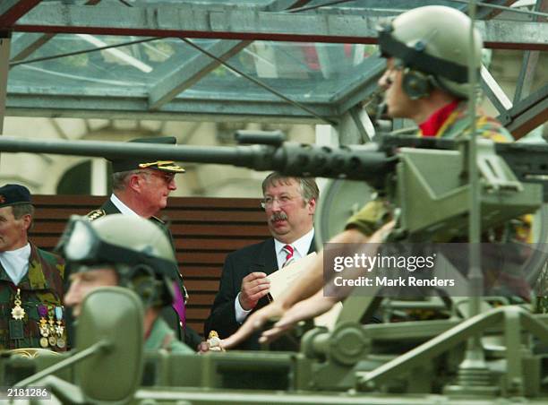 King Albert of Belgium and the Belgian Minister of Defence Andre Flahaut chat during the military parade, part of National Day celebrations July 21,...