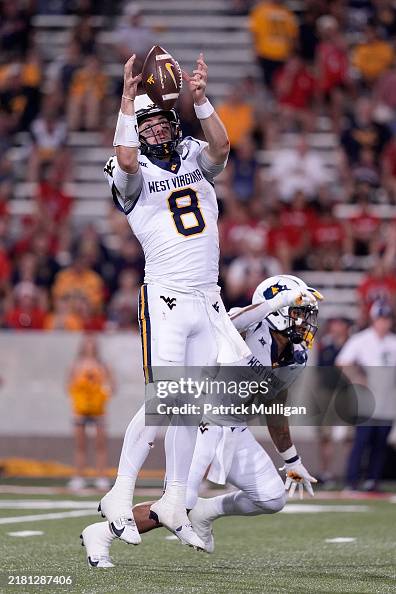 Marchiol Nicco Marchiol of the University of West Virginia catches a high snap ...