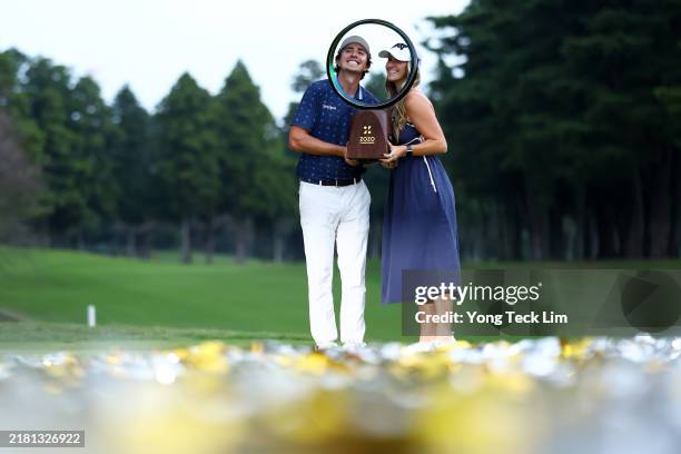 Nico Echavarria of Colombia and his girlfriend Claudia De Antonio pose with the trophy during the award ceremony following the final round of the...