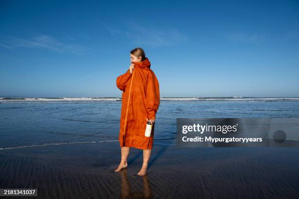swimmer on a beach - bathrobe stock pictures, royalty-free photos & images