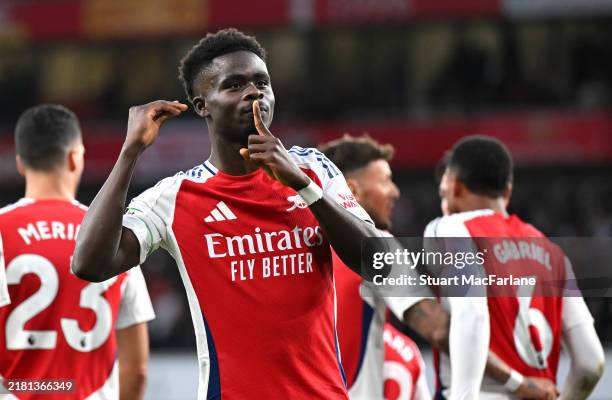 Bukayo Saka of Arsenal celebrates scoring his team's first goal during the Premier League match between Arsenal FC and Liverpool FC at Emirates...