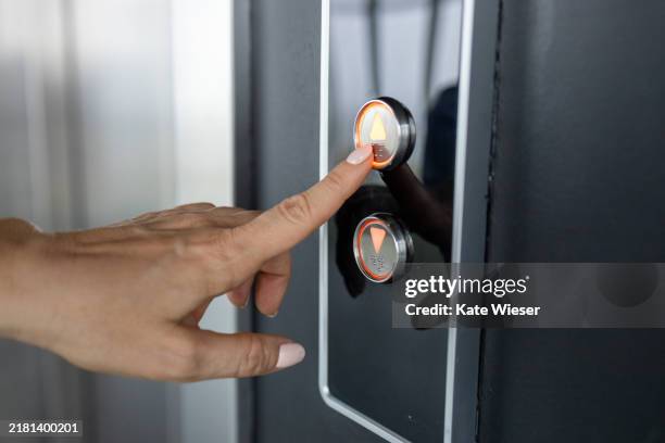 woman's hand push the up button in elevator - pressing elevator button stock pictures, royalty-free photos & images
