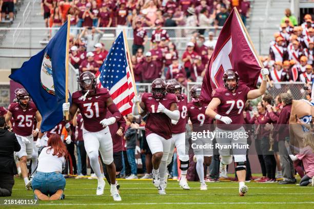 Members of the Virginia Tech Hokies run onto the field prior to the game against the Georgia Tech Yellow Jackets at Lane Stadium on October 26, 2024...