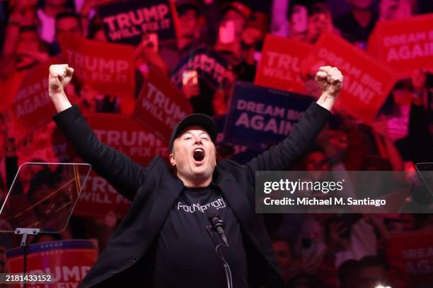 Tesla and X CEO Elon Musk raises his hands as he takes the stage during a campaign rally for Republican presidential nominee, former U.S. President...