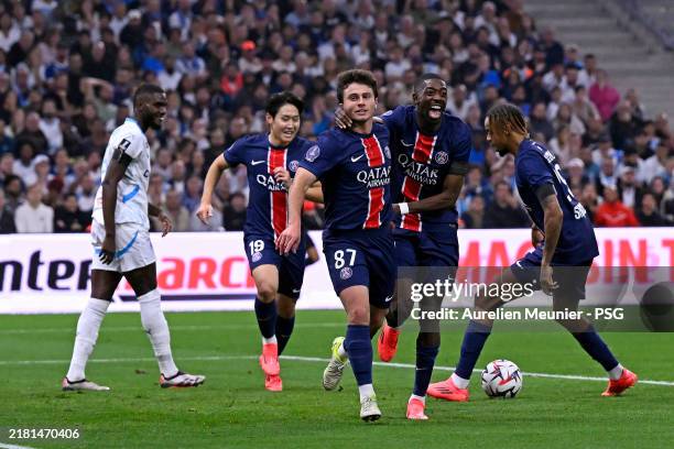 Joao Neves of Paris Saint Germain is congratulated by teammate Ousmane Dembele after scoring during the Ligue 1 match between Olympique de Marseille...