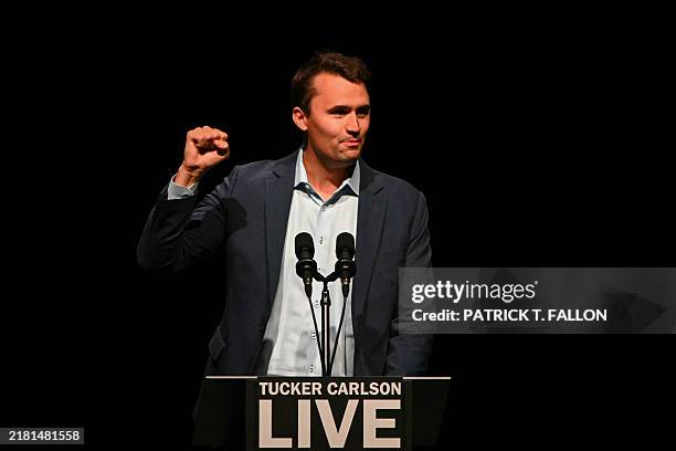Political activist Charlie Kirk speaks before a live interview with US commentator Tucker Carlson and former US President and Republican presidential...
