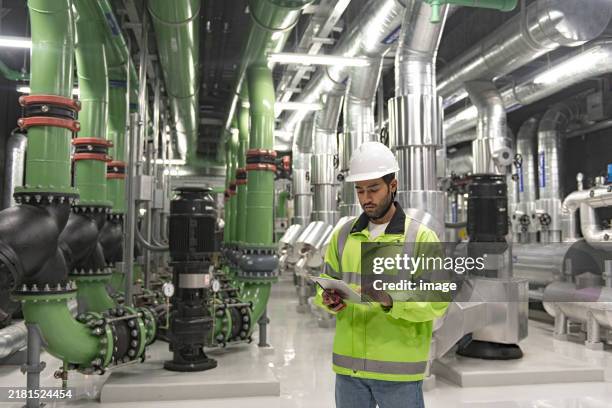 technician worker working in chiller plant room. - compressor stockfoto's en -beelden