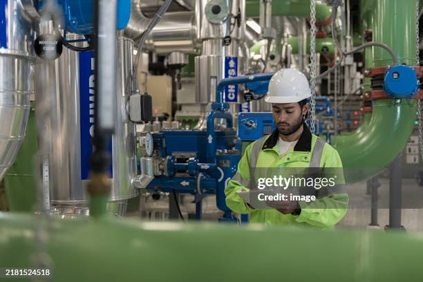 technician worker working in chiller plant room. - compressor stock pictures, royalty-free photos & images