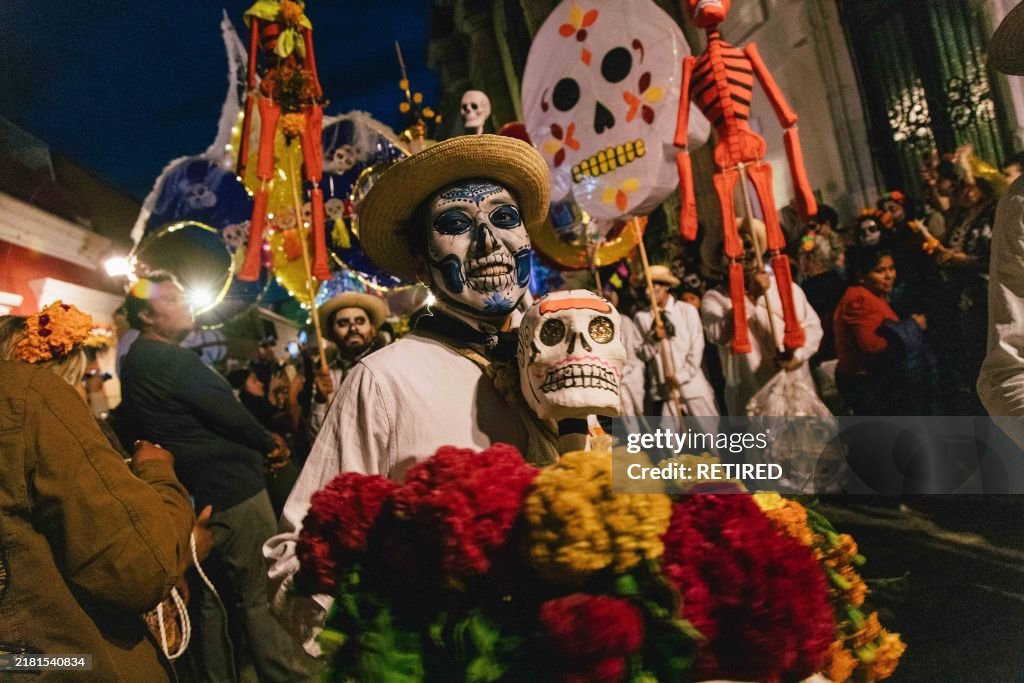 A boy with his face painted as skull takes part in a...