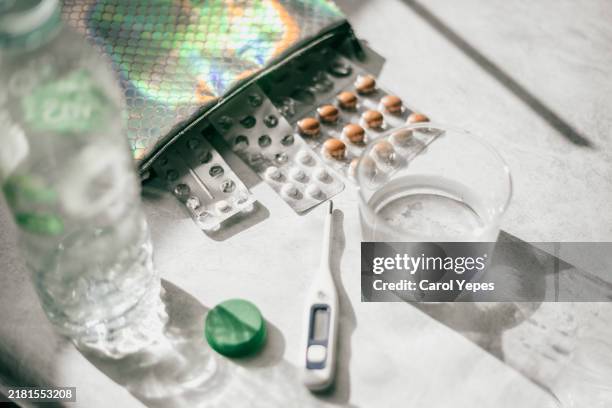 pills, vase of water and thermometer in grey surface - f water stock pictures, royalty-free photos & images
