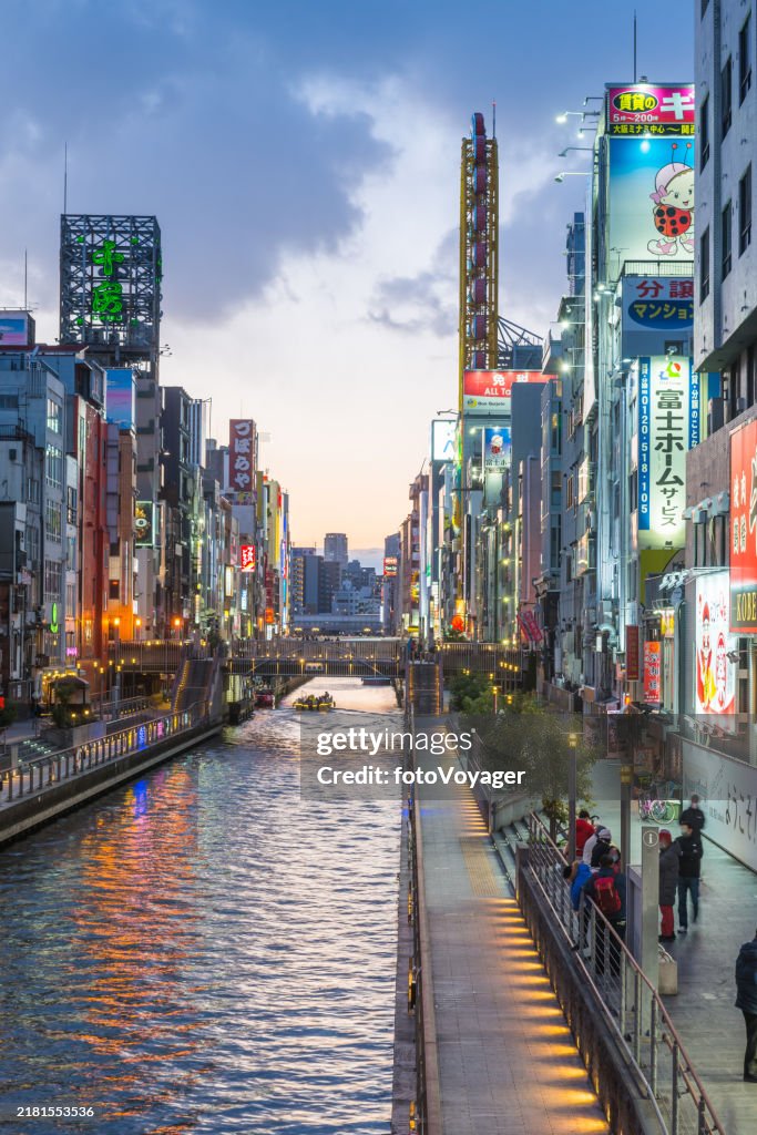 Osaka Dotonbori canal sunset between neon billboard cityscape Japan