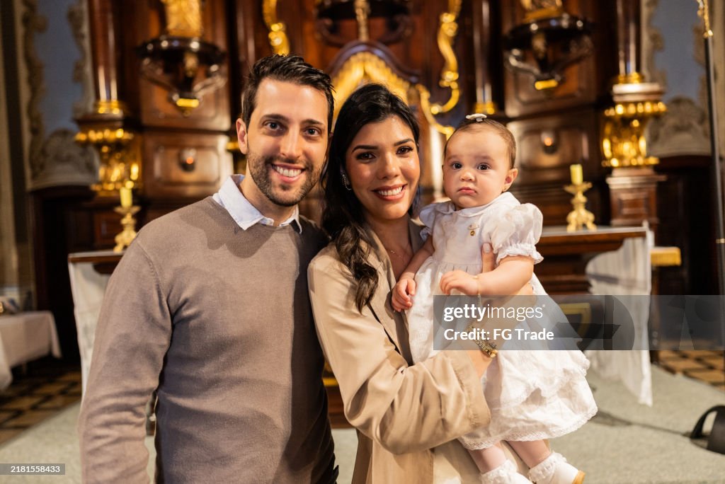 Portrait with a parents with their daughter at her baptism