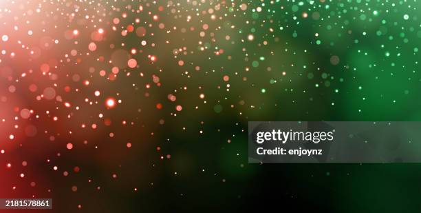 red and green sparkling christmas light background design - string lights black background stock illustrations