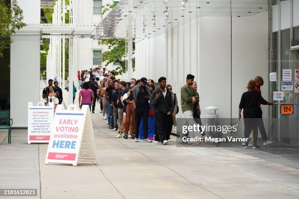 Voters head into a polling location to cast their ballots on the last day of early voting for the 2024 election on November 1, 2024 in Atlanta,...