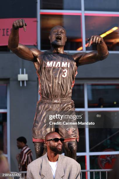 Dwyane Wade interacts with fans as they visit his statue that was unveiled on October 27th, prior to a game between the Miami Heat and the Detroit...